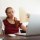 Businesswoman Sweating At Work With Broken Conditioner