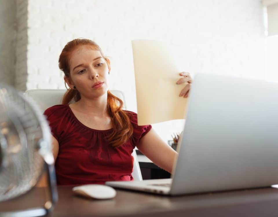 Businesswoman Sweating At Work With Broken Conditioner