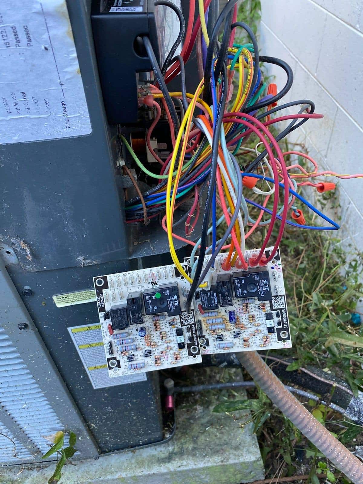 Picture of exposed wires on the outside portion of an HVAC Unit