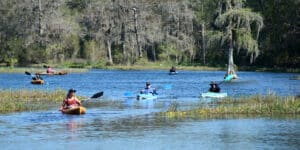 People paddling on the Rainbow River in Dunnellon Florida.